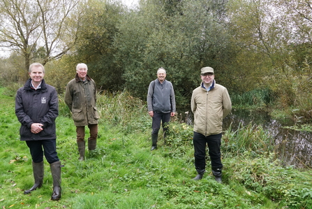 Tim Hill, Paul Barnes (landowner), John Pritchard (Ver Valley Society) and David Gittleson (The Debs Foundation) at a meeting at the River Ver in October 2020