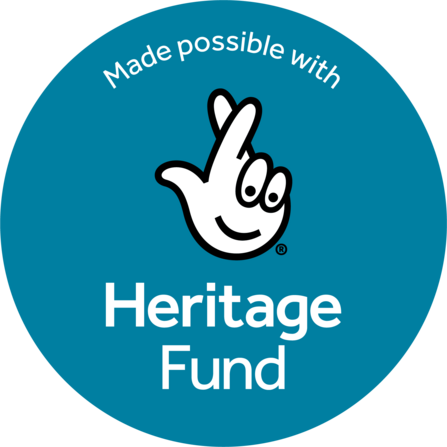 Round blue logo with icon of crossed fingers in white outlined by black in the centre. Small text at the top reads: Made possible with; Large text at the bottom reads: Heritage Fund