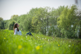 Women lying in wildflower meadow 30 Days Wild