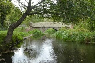 Archers Green bridge over the river mimran with a tree draping over the water's edge, nicely framed over the bridge