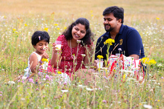 A family having a picnic in a wildflower meadow
