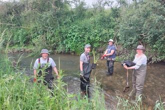 Volunteers planting on the River Ash