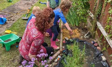 Family looking at garden pond 