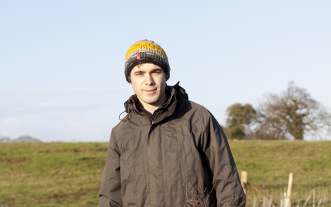 Andy stands by newly planted trees