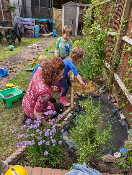 Family looking at garden pond 