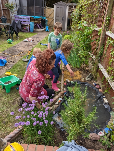 Family looking at a garden pond