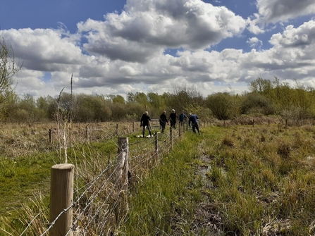  group of volunteers fixing a fence at Thorley Wash Nature Reserve