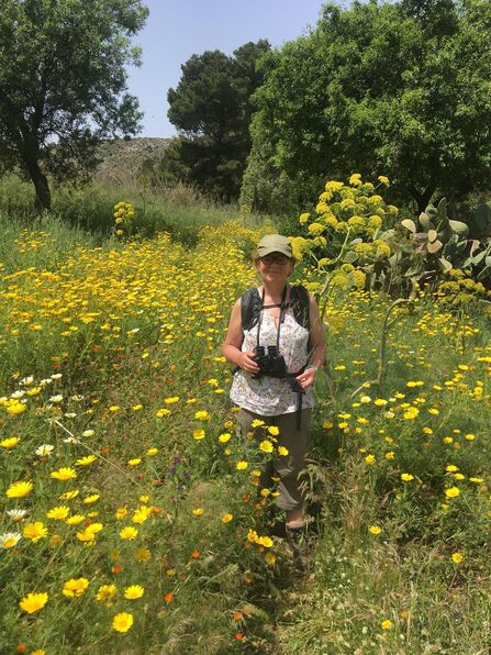 Lorraine Kirk in a meadow with wildflowers