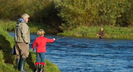 A man with a child angling