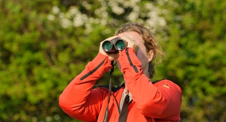 Young woman birdwatching