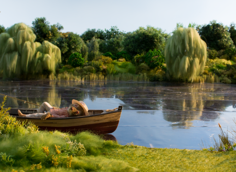 Wind in the willows character Ratty asleep on boat in river